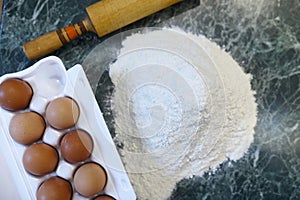 Different ingredients for preparing flour products on kitchen ta