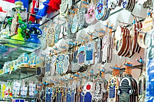 Different jewish souvenirs as Hamsa with Shalom Peace and other sale at the popular marketplace in Tel Aviv, Israel. Selective f