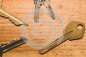 Different keys on a wooden background. safety and security concept