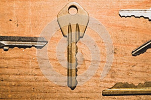 Different keys on a wooden background. safety and security concept