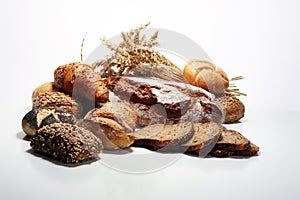 Different kinds of bread and bread rolls on board from above