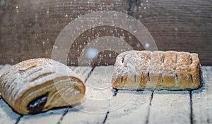 Different kinds of bread rolls on black board from above