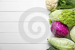 Different kinds of cabbage on white wooden background