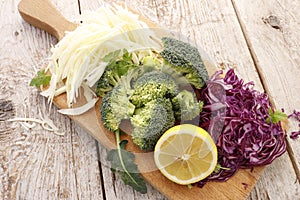Different kinds of cabbage on a wooden board
