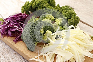 Different kinds of cabbage on a wooden board