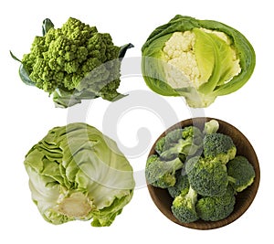 Different kinds of cabbage in a wooden bowl. Broccoli, Brussels sprouts, Roman cauliflower, green cabbage isolated on white backgr