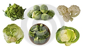 Different kinds of cabbage in a wooden bowl. Broccoli, Brussels sprouts, Roman cauliflower, green cabbage isolated on white backgr