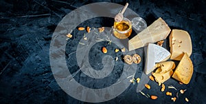 Different kinds of cheese with nuts and honey
