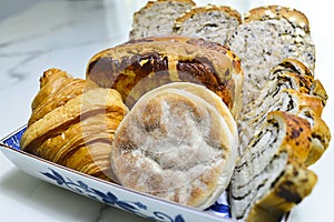 Different kinds of fragrant fresh bread on the table.
