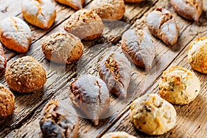 Different kinds of fresh bread on wooden table. Isolated assortment of bread on brown background