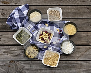 Different kinds of grains and rice in small bowl with blue and white chequered napkin