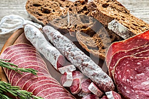 Different kinds of salami with dark-rye bread photo