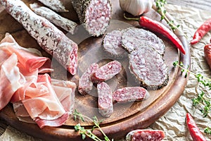 Different kinds of sausage on the wooden background photo