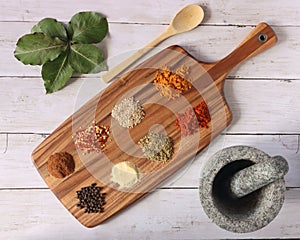 Different kinds of spices on a wooden table