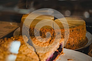 Different kinds of tarts at cafes or coffeeshops. A blueberry pie and cheesecake on background on black plate in display photo