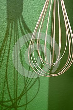 Different kitchen tools for cooking hanging on the wall.