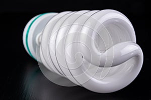 Different light bulbs and fluorescent lights on a wooden table. New types of lighting