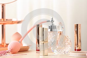 Different lipsticks and perfume bottle