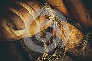 Different loaves of bread cooked with flour and gluten-free wheat on a wooden table