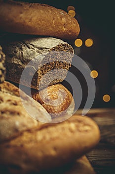 Different loaves of bread cooked with flour and gluten-free wheat on a wooden table