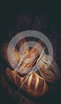 Different loaves of bread cooked with flour and gluten-free wheat on a wooden table