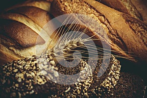 Different loaves of bread cooked with flour and gluten-free wheat on a wooden table