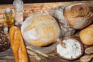 Different loaves of bread cooked with flour and gluten-free wheat on a wooden table