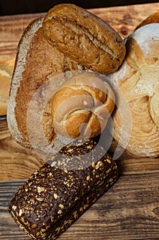 Different loaves of bread cooked with flour and gluten-free wheat on a wooden table