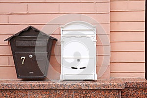 Different mailboxes on brick wall of building outdoors