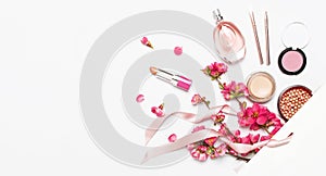 Different makeup cosmetic. Ball blush rouge lipstick concealer bottle of perfume makeup brush spring pink flowers in white gift