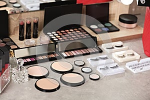 Different makeup products and accessories on dressing table