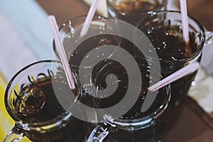 Different many soft drink are in a glass on wooden table. sparkling water.