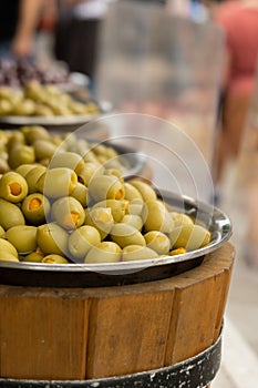 Different marinated olives and local food on street market in Gdansk, Poland. Selling and buying street food. Assortment