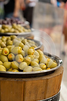 Different marinated olives and local food on street market in Gdansk, Poland. Selling and buying street food. Assortment