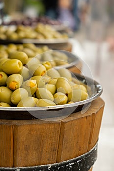 Different marinated olives and local food on street market in Gdansk, Poland. Selling and buying street food. Assortment