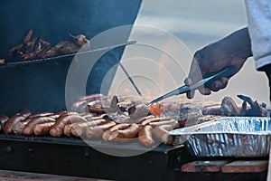 Different Meats Cook Over Open Flame On Grill