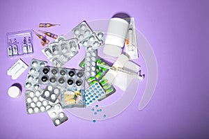 Different medicines on a lilac background. Varying drugs for different purposes. Doctor`s prescription, each kind of medicine is