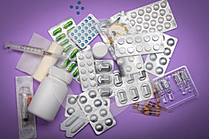 Different medicines on a lilac background. Varying drugs for different purposes. Doctor`s prescription, each kind of medicine is