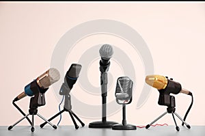 Different microphones on grey table. Journalist`s work