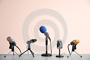 Different microphones on grey table. Journalist`s work