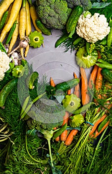 Different mixed colorful health vegetables on the table, Carrot, cucumber,green pea, cauliflower, broccoli, garlic, dill, parsley,