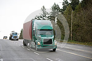 Different models of Semi trucks convoy on wide multiline road photo