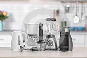 Different modern kitchen appliances on table indoors.