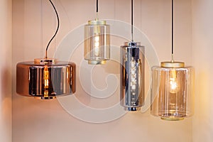 Different modern streamlined mirror copper chandeliers. Bubble metal copper shade pendant