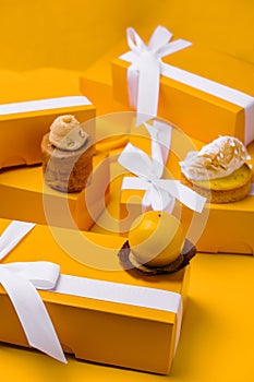 different mousses cakes in gift boxes