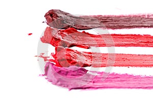 Different multi colored samples of a smudged lipstick