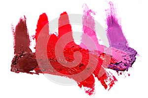 Different multi colored samples of a smudged lipstick