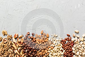 different nuts frame background. Close up, top view, flat lay with vopy space. Walnut, pistachios, almonds, hazelnuts