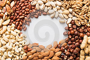 different nuts frame background. Close up, top view, flat lay with vopy space. Walnut, pistachios, almonds, hazelnuts
