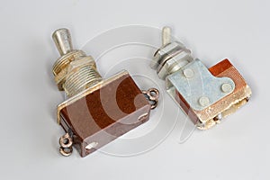 Different old electrical toggle switches on a gray background